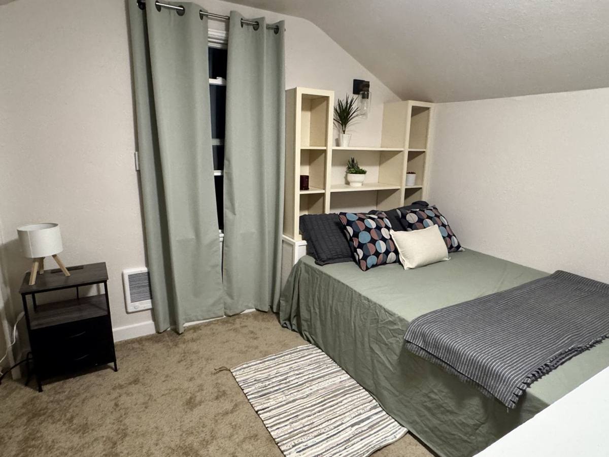 Private bedroom with full bed and built-in shelves